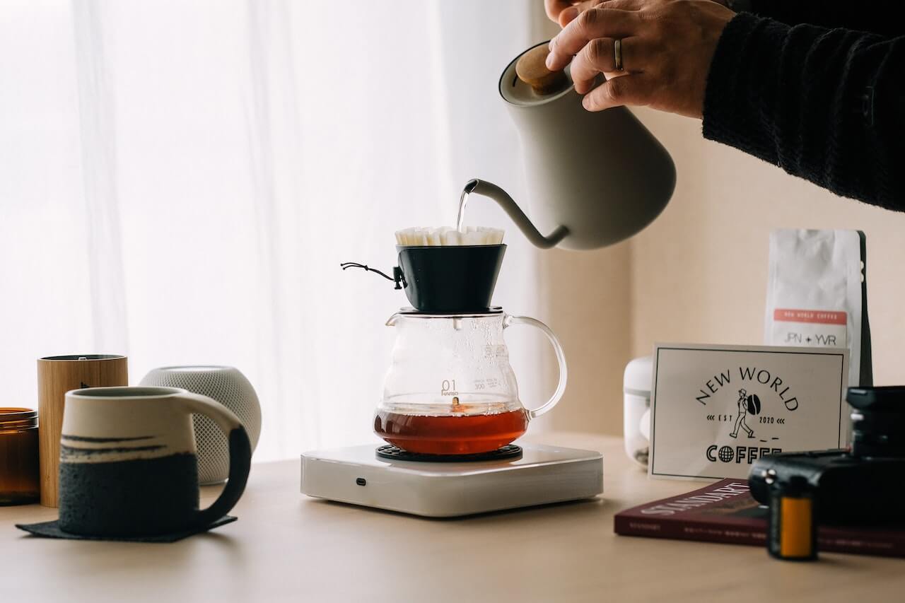 a person brewing pour over coffee