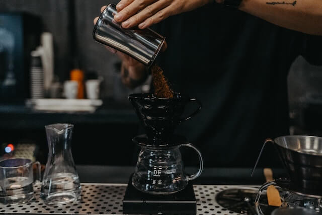 a person pouring coffee