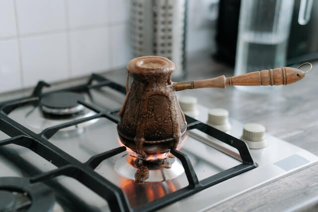 brown ceramic teapot on stove