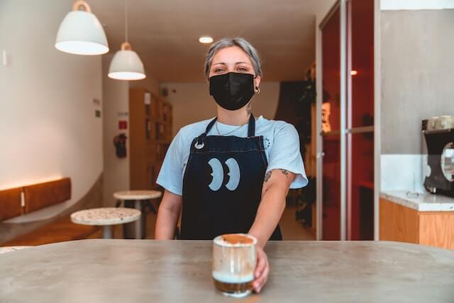 barista serving iced coffee